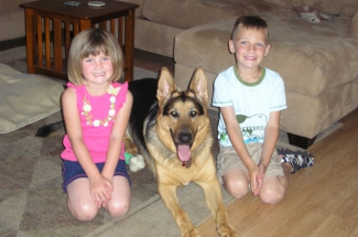 Kids with German Shepherd dog